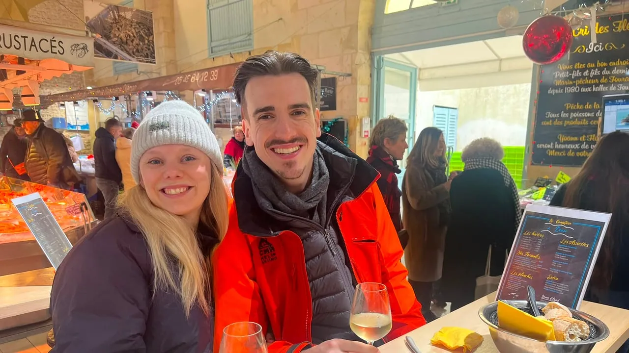 Tess and Jonny with white wine at the covered market